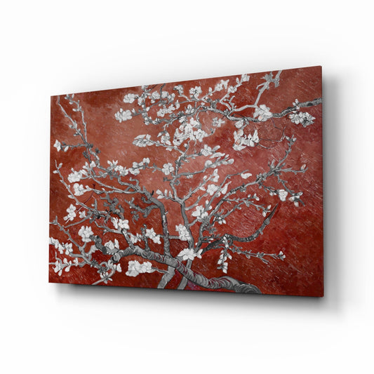 Glass wall art panel displaying white flowering branches against deep terracotta red background, shown at angled perspective with shadow.