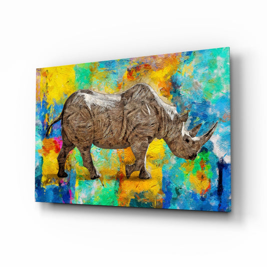 Angled view of glass wall art featuring a detailed rhinoceros against a vibrant multicolored abstract background in blues, yellows, greens, and oranges.