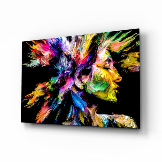 Angled view of colorful glass wall art featuring two profile silhouettes with vibrant paint-stroke textures in rainbow hues against black background.
