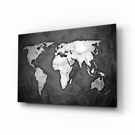 Angled perspective view of a world map with white and silver continents on a dark charcoal textured glass panel.