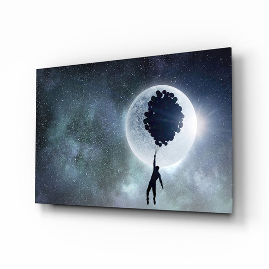 Silhouetted figure holding bundle of dark balloons floating toward glowing full moon against starry night sky on glass panel, angled perspective view.