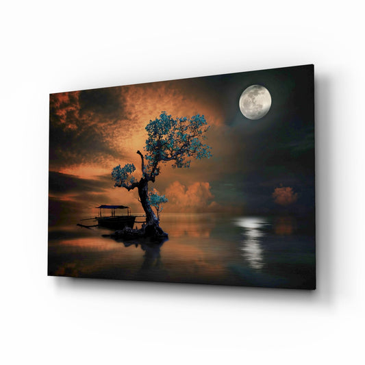 Glass wall art panel displaying a moonlit lakeside scene with a gnarled tree featuring turquoise foliage, silhouetted boat, and warm orange sunset sky.
