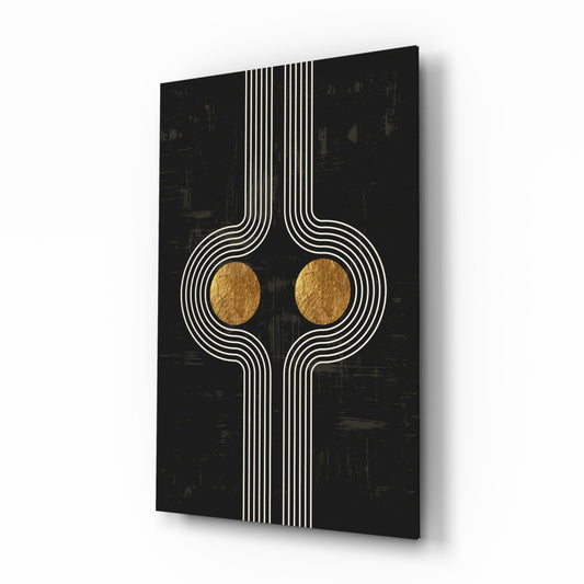 Modern glass wall art with symmetrical white linear design and two gold circular elements on black textured background, angled perspective view.