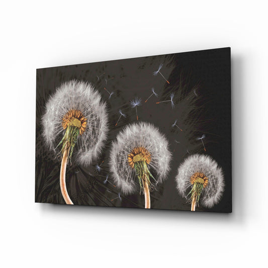 Three dandelion seed heads with yellow centers displayed on dark charcoal glass, angled perspective showing dimensional depth and shadow effect.