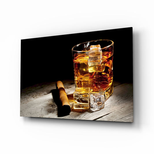 Glass of amber whiskey with ice cubes and a cigar on weathered wood surface against black background.