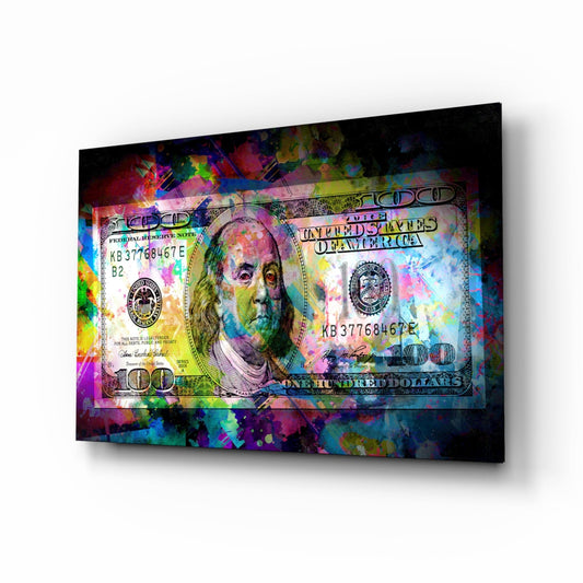 Colorful glass wall art displaying a vibrant $100 bill with Benjamin Franklin's portrait amid splattered paint effects in blues, pinks, and yellows, viewed at an angled perspective.
