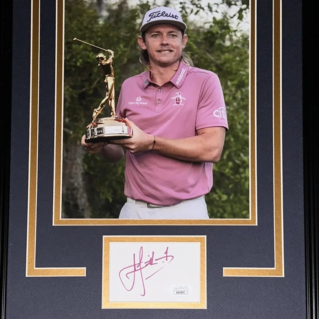 Autographed TPC trophy signature with golfer figure held by man