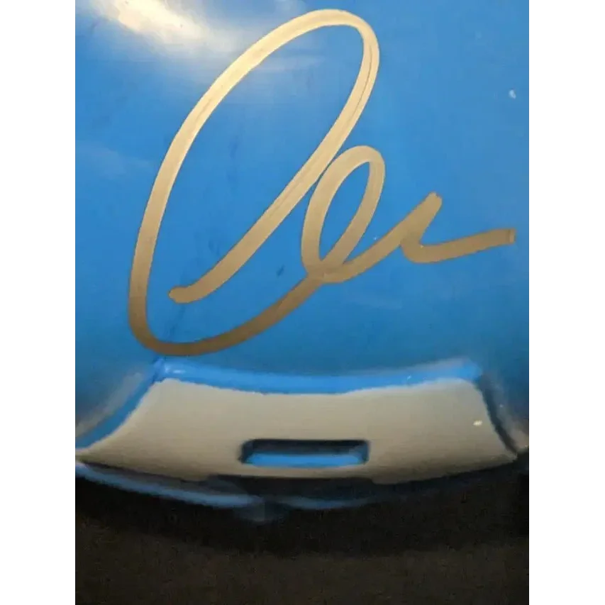 Blue object with golden cursive design from Chris Evans Autographed Captain America Mask
