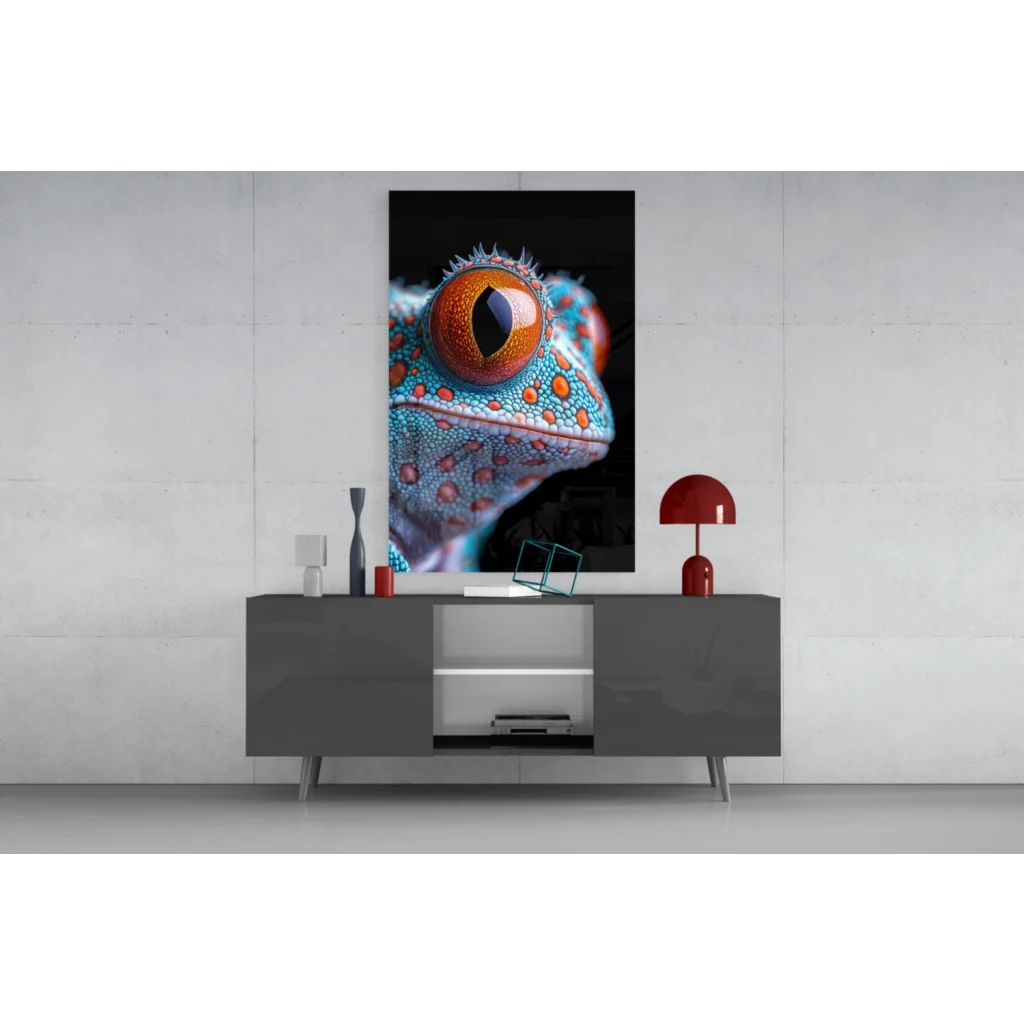Vibrant turquoise and orange gecko eye glass wall art on gray console