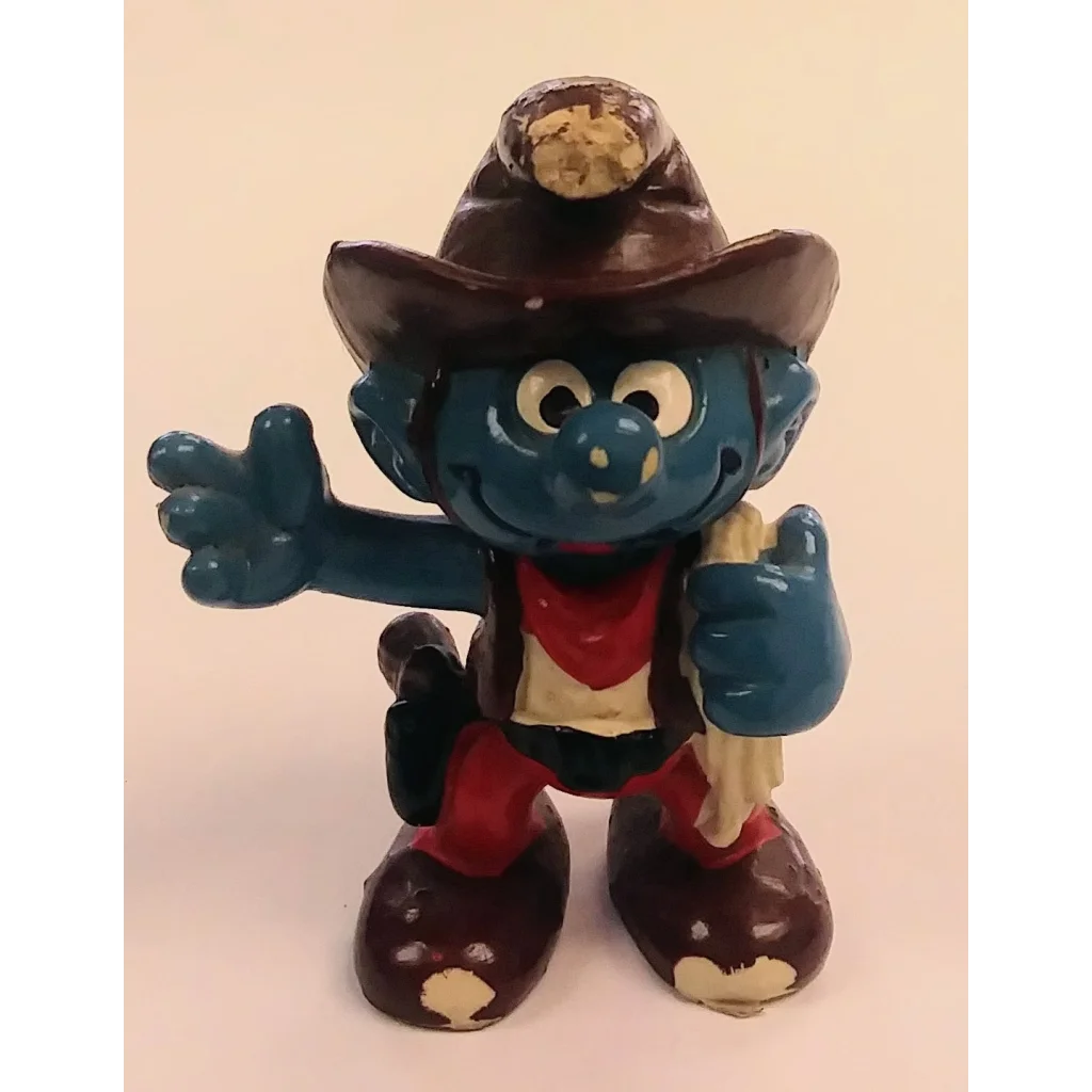 Cowboy Smurf figurine in hat, boots, red vest, blue skin, holding stick