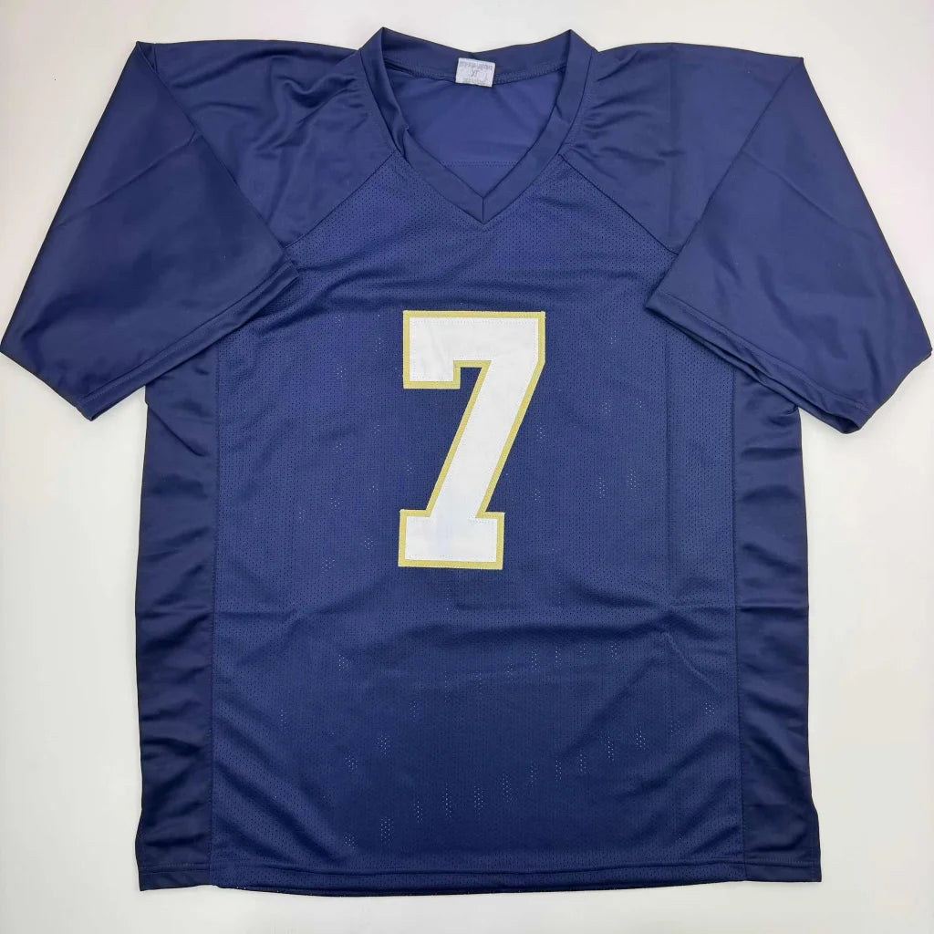 Navy blue custom jersey with number 7 from professional sports league, autographed by THEISMANN