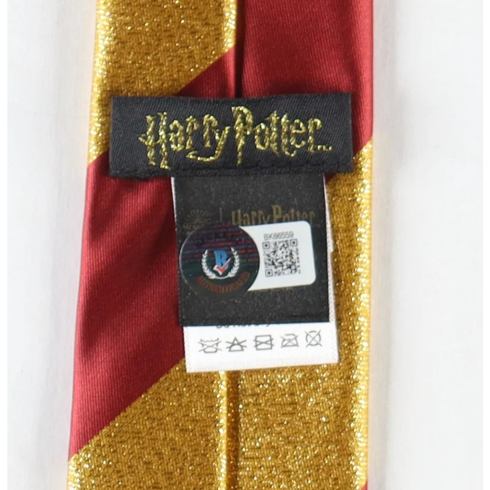 Red and gold striped Harry Potter tie with care tag from Daniel Radcliffe signed Gryffindor merch
