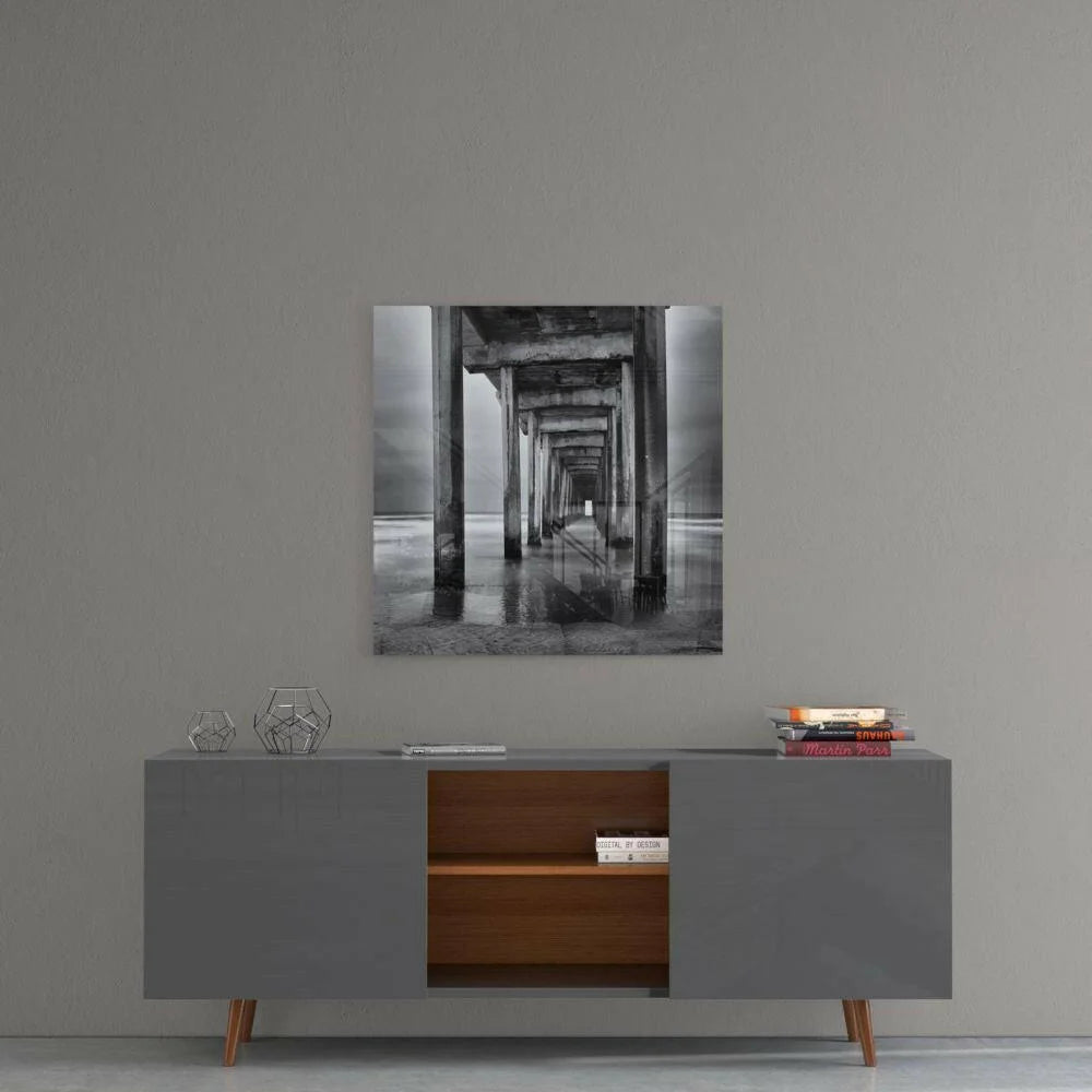 Black-and-white glass wall art of symmetrical concrete tunnel pillars