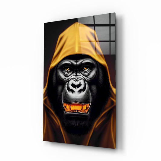 Glass wall art panel displaying a menacing gorilla wearing a yellow hood with glowing orange eyes and mouth, mounted at an angle.