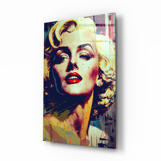 Pop art style glass wall art featuring a blonde woman with red lips and gold-toned hair against vibrant yellow, red, and dark blue colors, displayed at an angle.