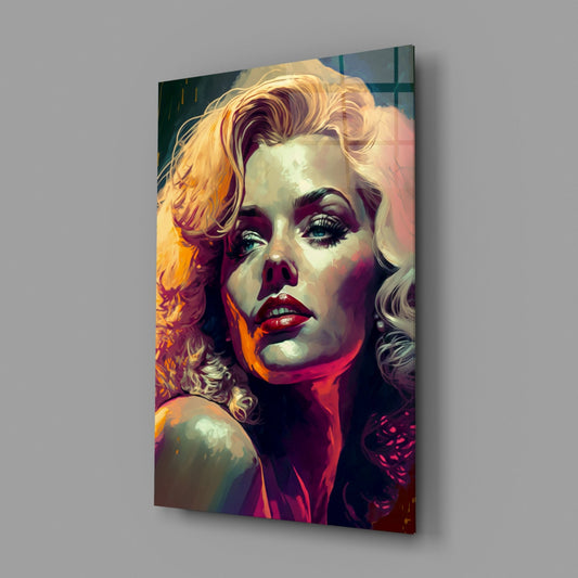 Glass wall art panel displaying a portrait of a blonde woman with bold red lips and purple eyeshadow against warm golden and crimson tones, angled view.