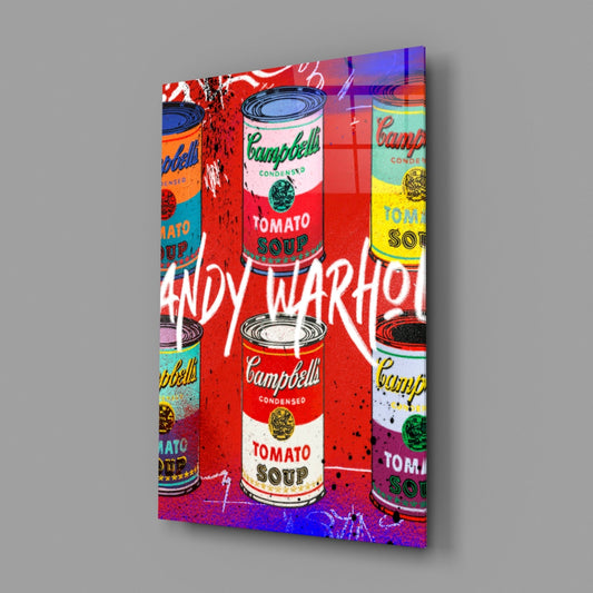 Pop art glass wall panel featuring Campbell's soup cans with colorful overlays and "ANDY WARHOL" text, displayed at an angle against gray background.