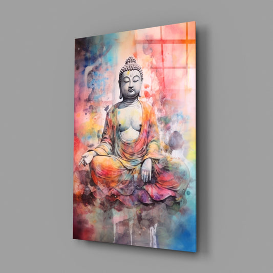 Angled view of glass wall art displaying a grayscale Buddha figure surrounded by vibrant watercolor splashes in pink, orange, yellow, and blue tones.