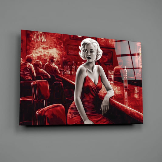 Glass wall art featuring a stylized woman in a red dress at a bar, displayed at an angle against a gray wall.