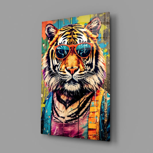 A vibrant glass wall art panel displaying a colorful pop-art tiger wearing red aviator sunglasses against a multicolored graffiti background.