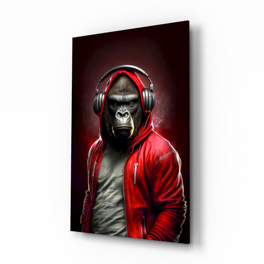 A gorilla wearing red headphones and a red hoodie over gray shirt is displayed on a black glass panel against a dark background.
