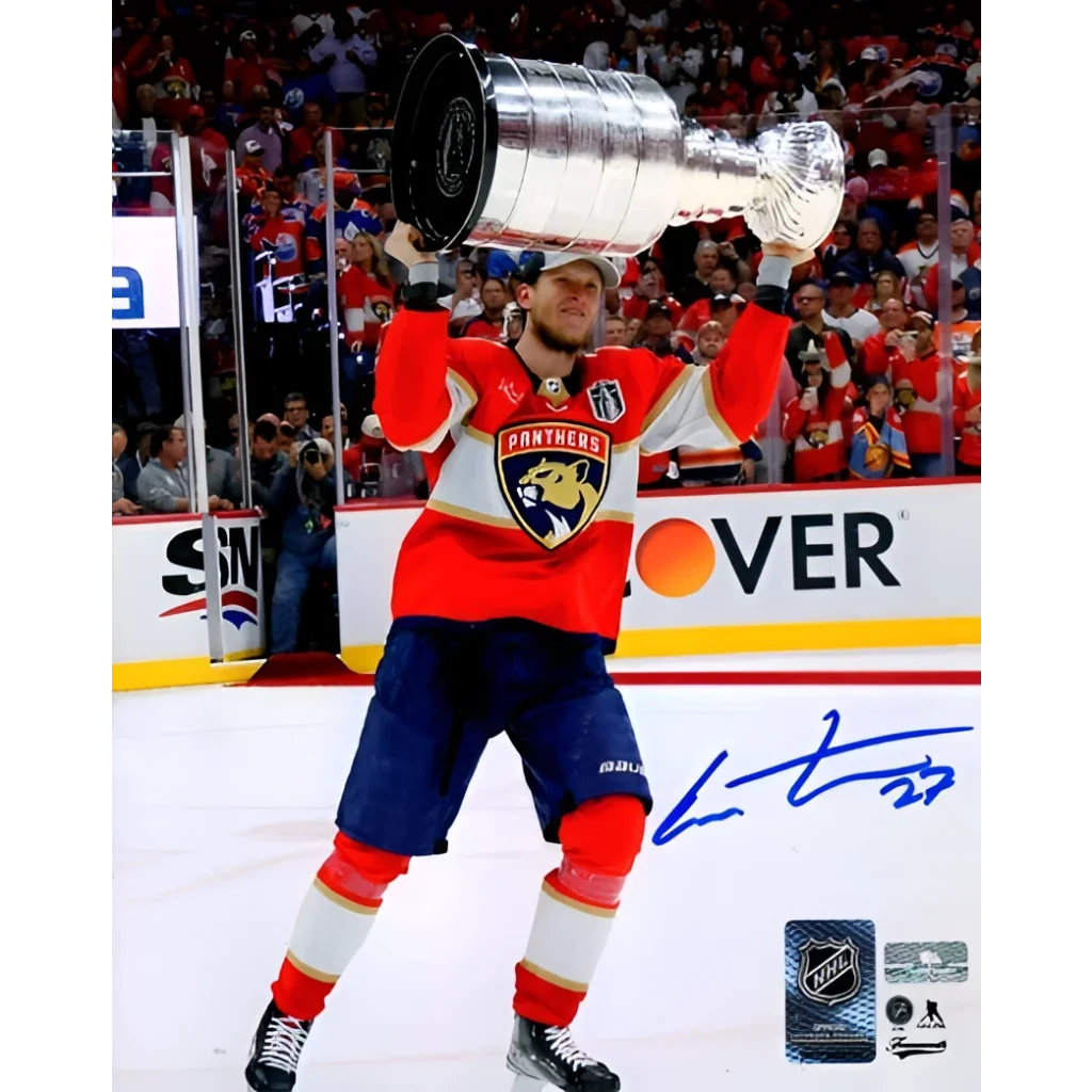 Eetu Luostarinen holds Stanley Cup Trophy in Florida Panthers jersey
