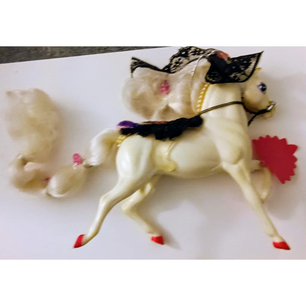 Enchanted Kingdom Horse figurine with white body, red hooves, black bridle, decorative saddle