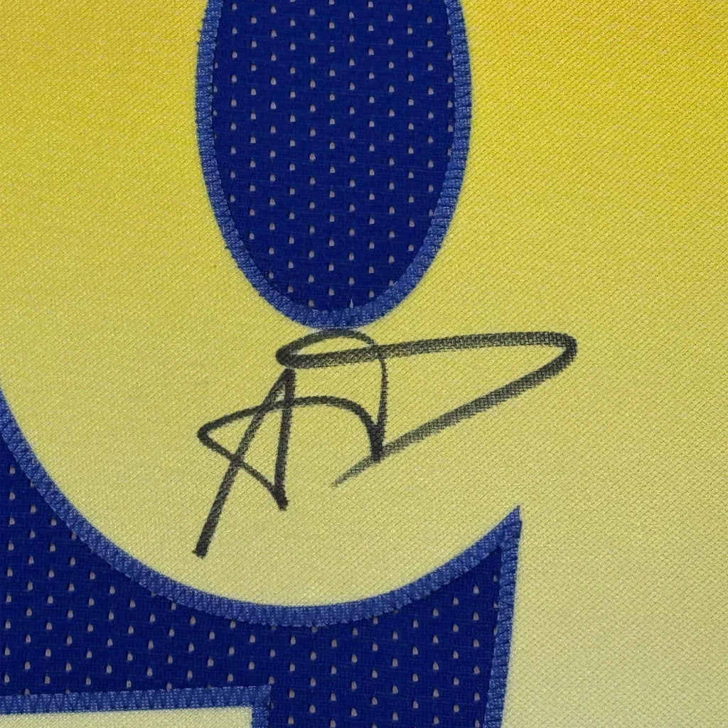 A close-up of a yellow and blue basketball jersey featuring anthony davis signature framed autographed collectible