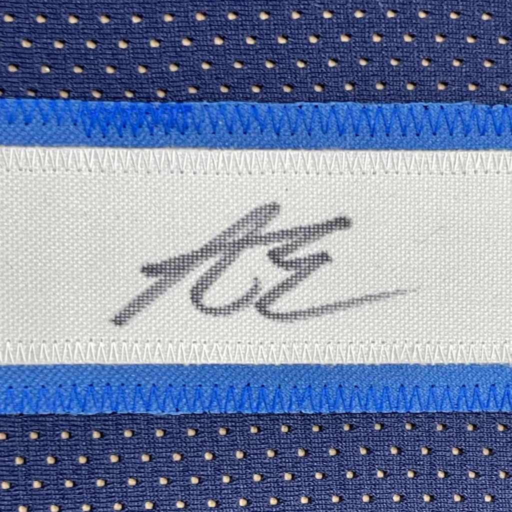 Blue and white perforated mesh basketball jersey with stitched signature label framed and signed by Anthony Edwards