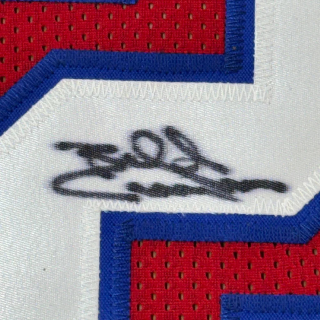 Red and blue Billy Cunningham signed sports jersey with black marker autograph in frame