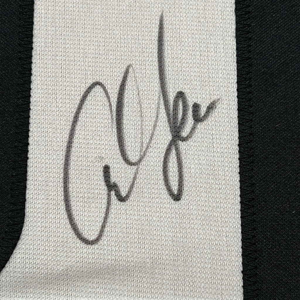 Autographed white textile fabric with black stitching from Legendary USA Track Jersey collectible