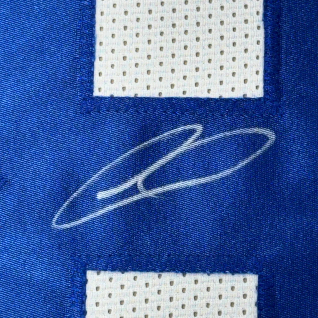 Blue fabric with white perforated section and CeDee Lamb autograph in professionally framed jersey