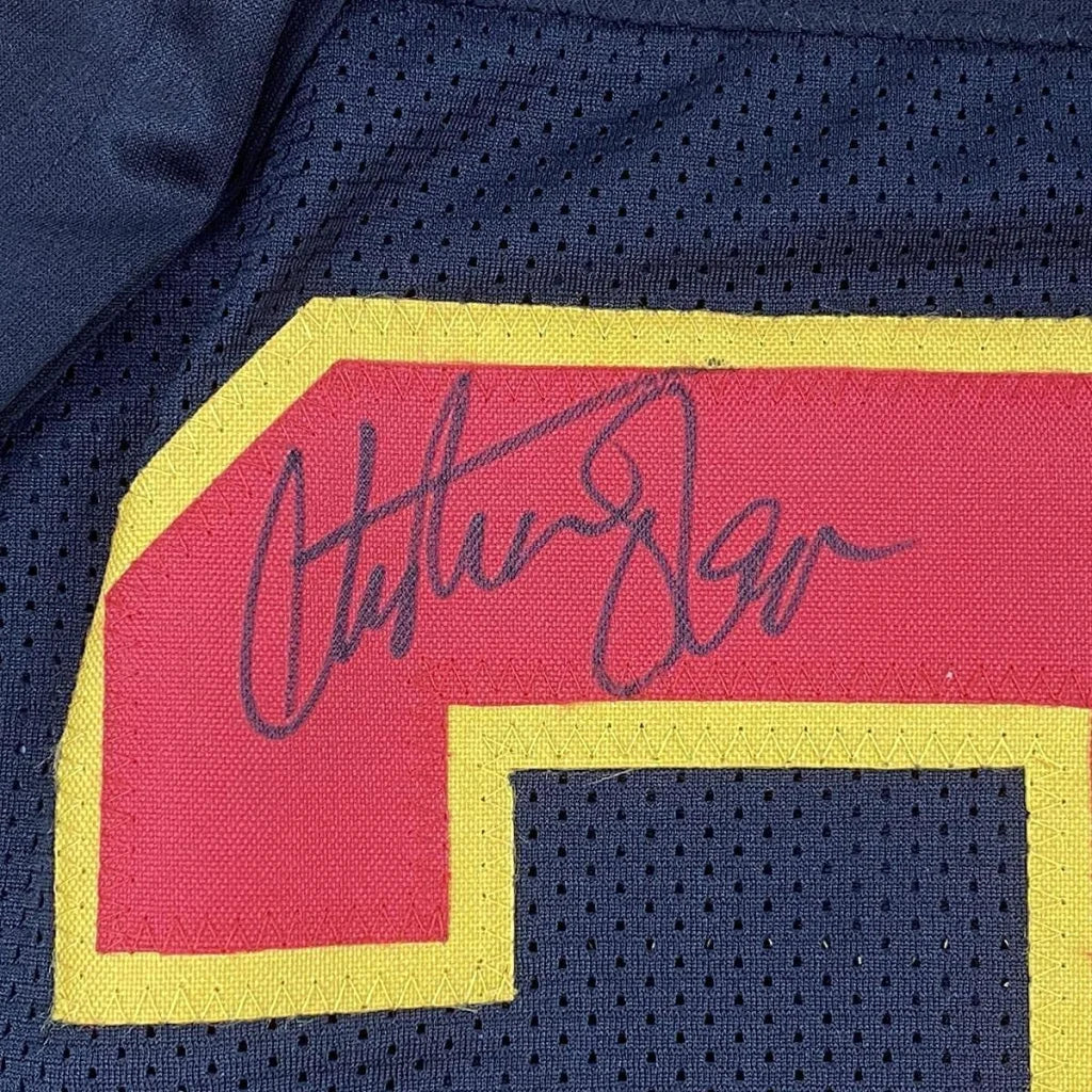 Autographed Christian Okoye Chiefs jersey with Hall of Fame plaque on display