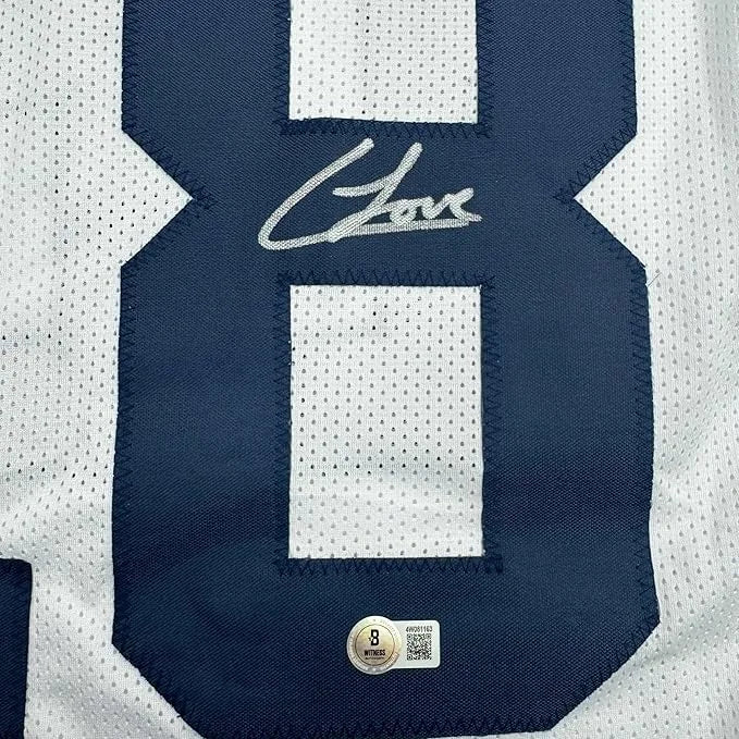 Framed autographed navy blue and white colston loveland football jersey number 8 with silver stitched signature and authentication sticker