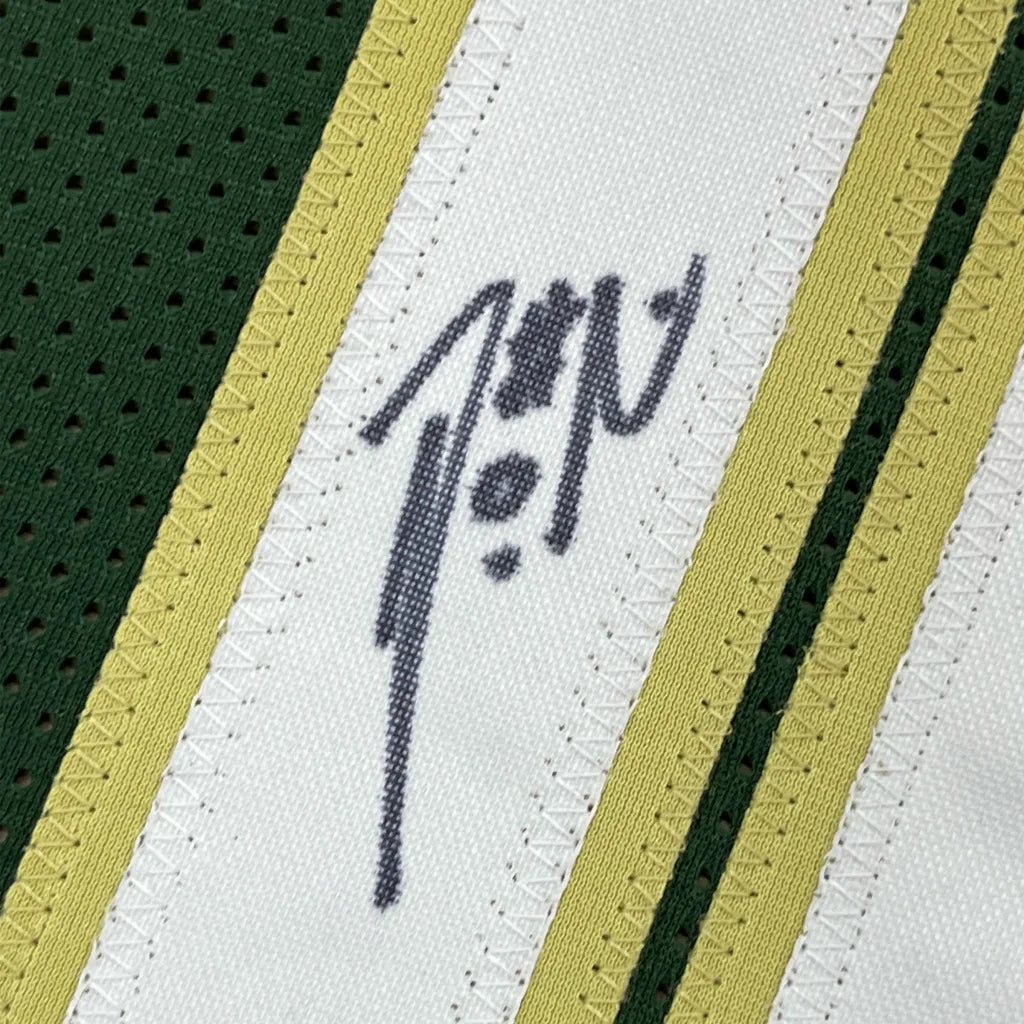 Autographed green, white, and gold Damian Lillard Milwaukee Bucks jersey with photos