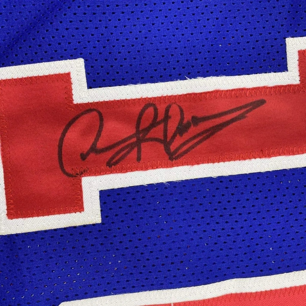 Framed autographed dennis rodman detroit blue basketball jersey with red mesh stripe and white trim signed in black ink