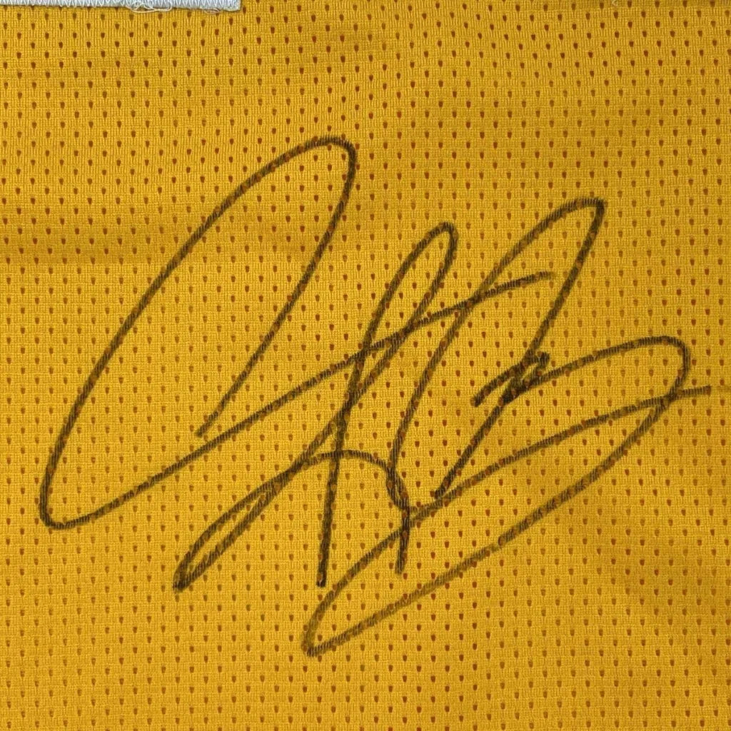 Black ink signature on yellow mesh fabric of framed autographed dennis rodman los angeles basketball jersey