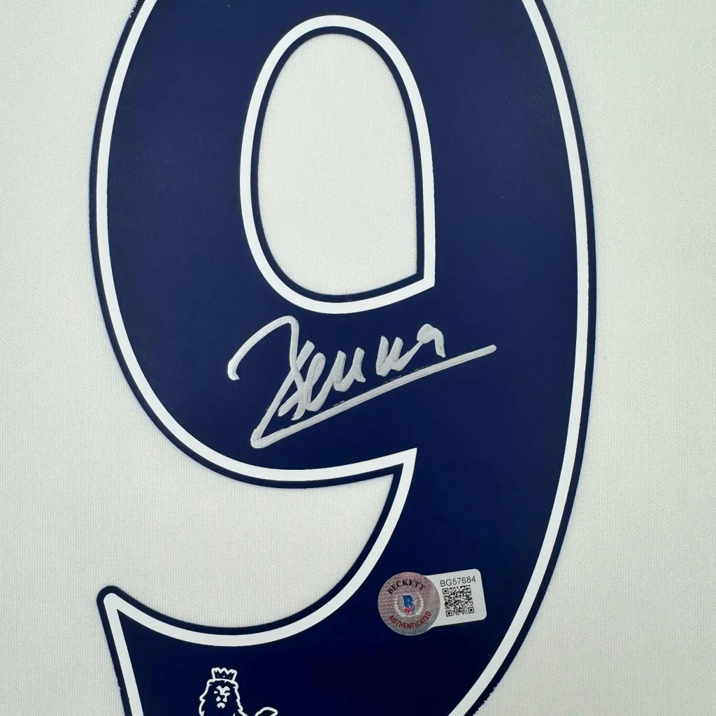 A navy blue number nine patch with white outline featuring an autograph and beckett authentication on a framed dimitar berbatov tottenham jersey