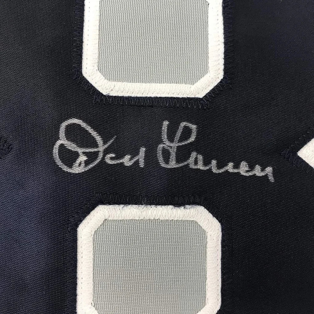 Autographed navy blue Yankees jersey with white and gray numbers, framed with photos