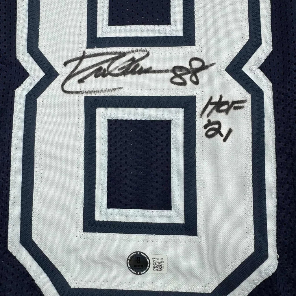 Framed autographed white and navy blue mesh football jersey signed by eric gordon with number 8 displayed