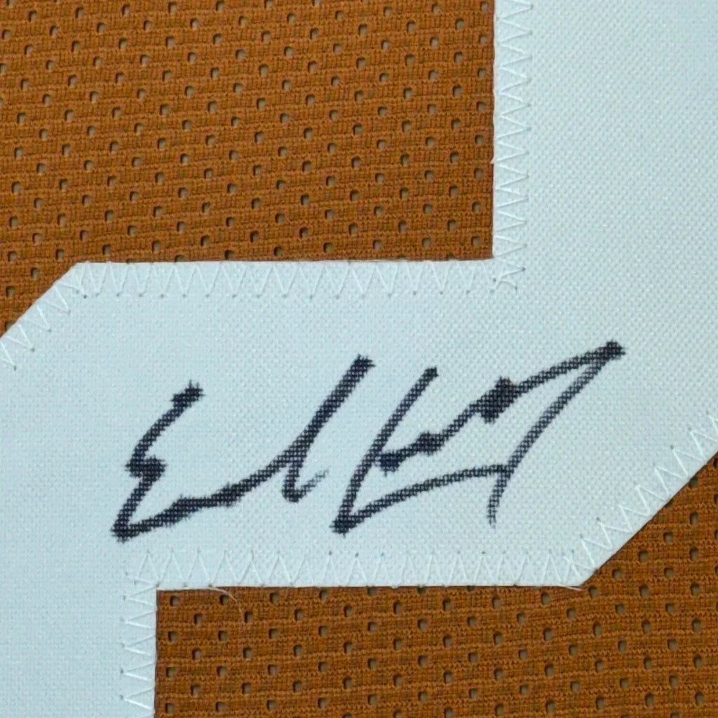 Framed autographed Earl Campbell Texas orange jersey with black ink signature on white patch