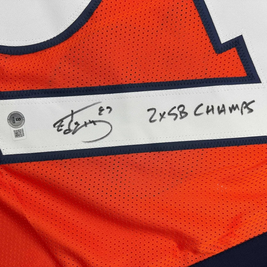 Autographed orange Broncos jersey with 2x SB CHAMPS inscription in a professionally framed display