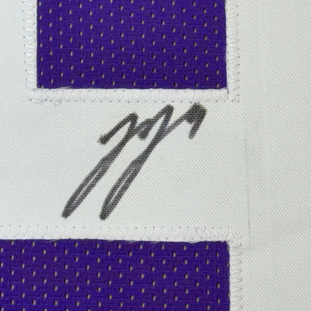 Framed autographed J.J. McCarthy Minnesota Purple jersey with black ink signature on white patch and purple mesh border, Beckett BAS COA