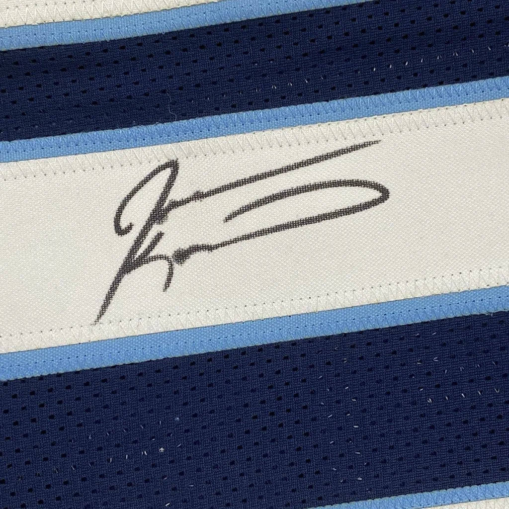 Black ink signature on a white woven label bordered by light blue and navy mesh fabric on tennessee football jersey