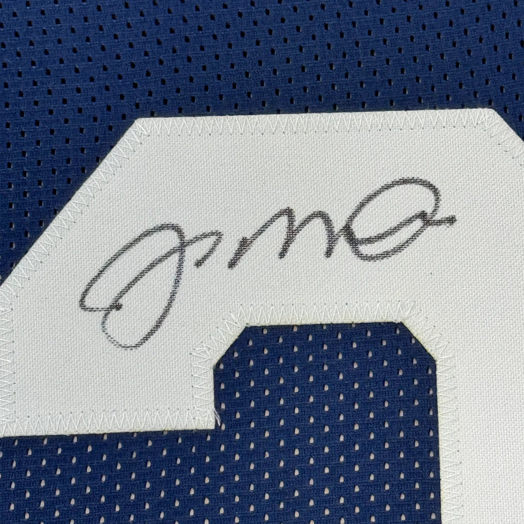 Autographed Notre Dame Blue Jersey with 5x7 Photos of Joe Montana displayed in frame