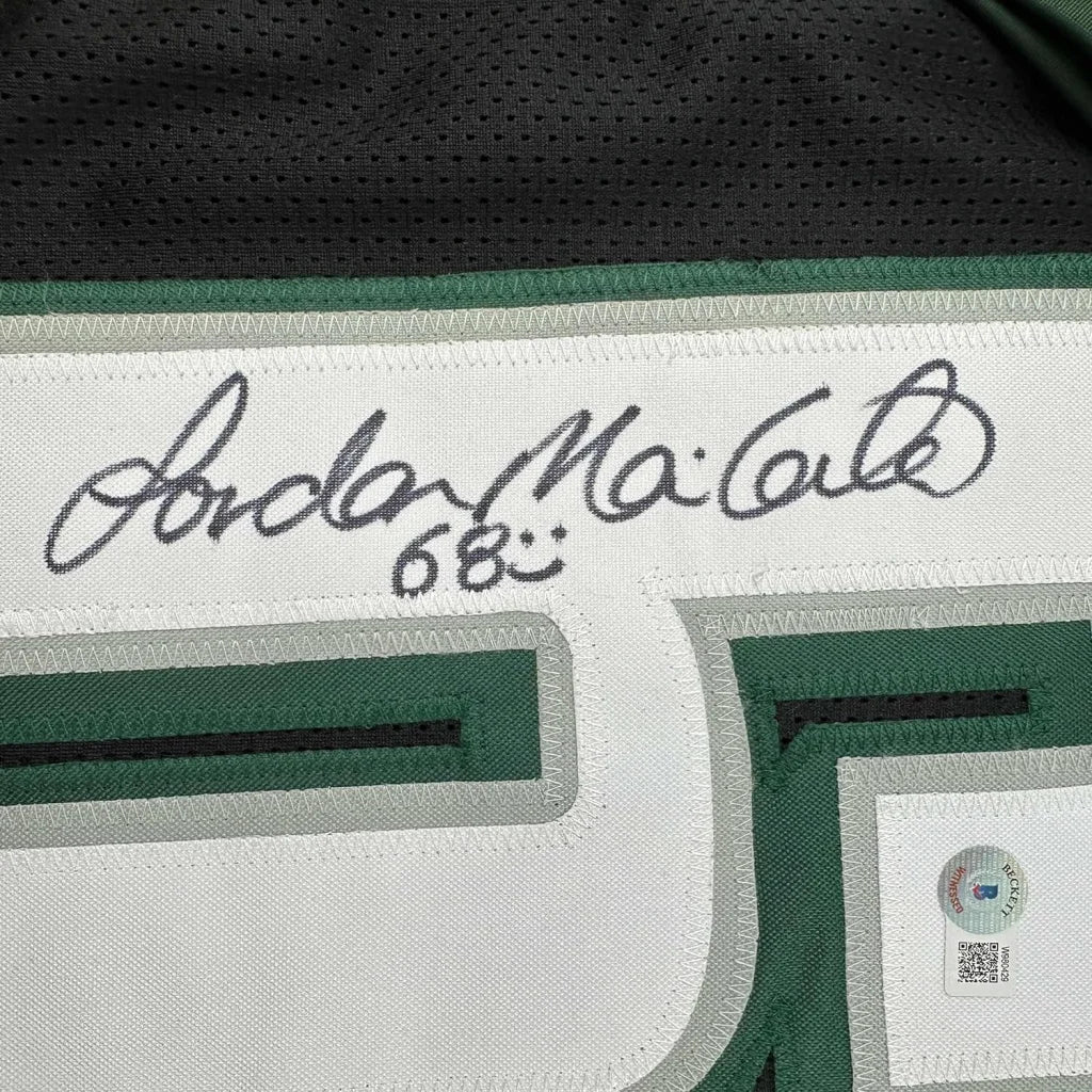 Framed autographed white and green jordan mailata basketball jersey with black signature above number 68