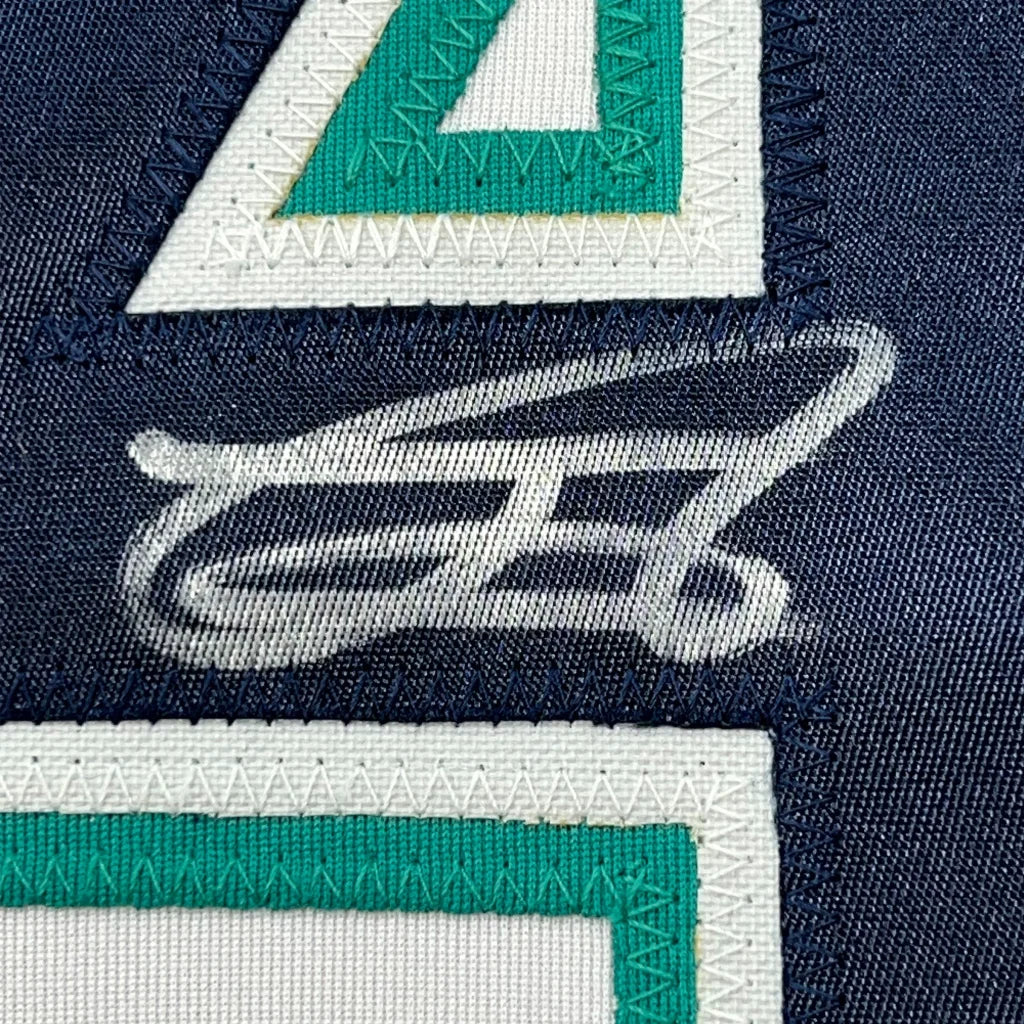 Dark blue Mariners jersey fabric with stitched white and green numbers and signature