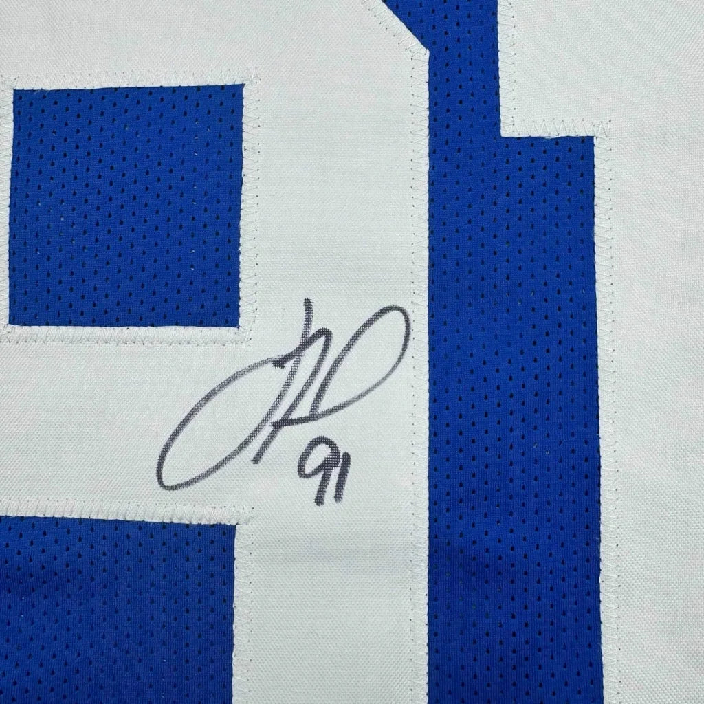 Blue and white mesh sports jersey with a black marker autograph, part of Tuck 91 collection