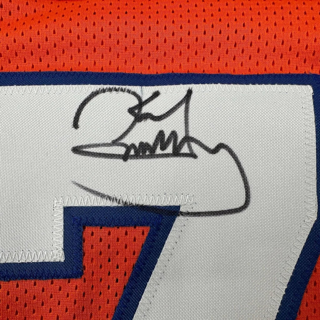 Black ink signature on white fabric patch of orange and blue denver football jersey framed autographed karl mecklenburg