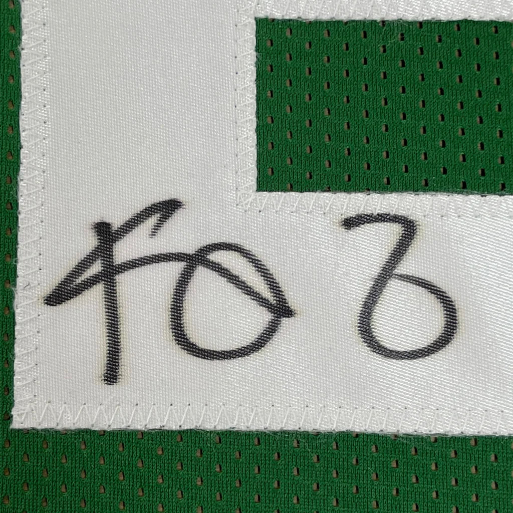 Green and white mesh athletic basketball jersey with black signature on white label framed autographed kevin garnett